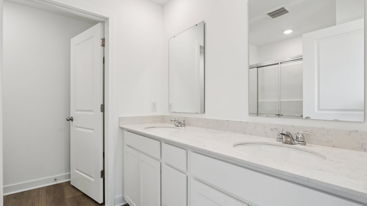 primary bathroom with dual vanity
