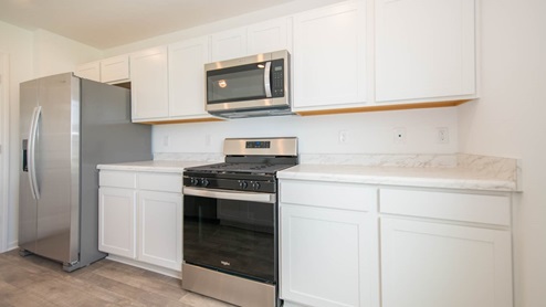 The kitchen has laminate countertops and stainless appliances