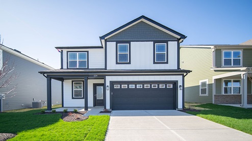 two story home with dark garage door