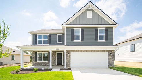 two story home with steep roof pitch and front porch