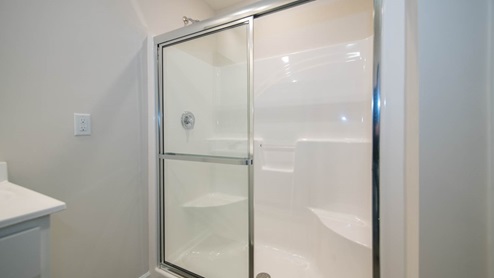 Primary bathroom with dual sinks and shower