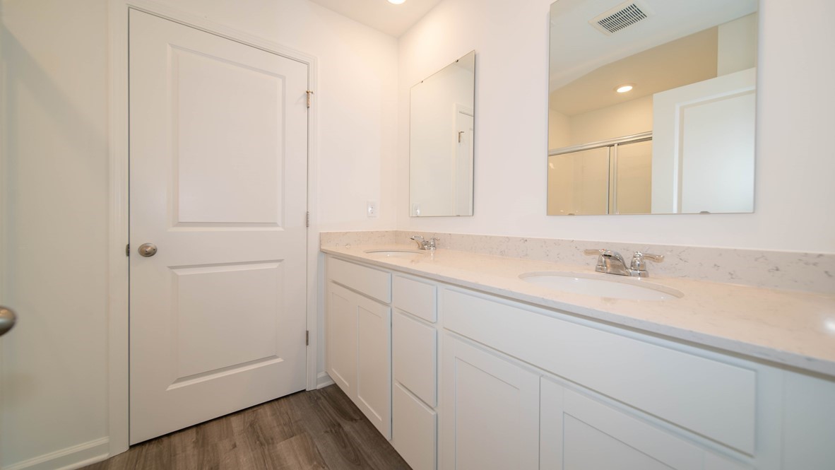 primary bathroom with dual vanity