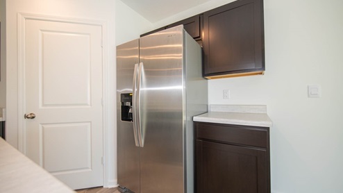 The kitchen includes stainless appliances