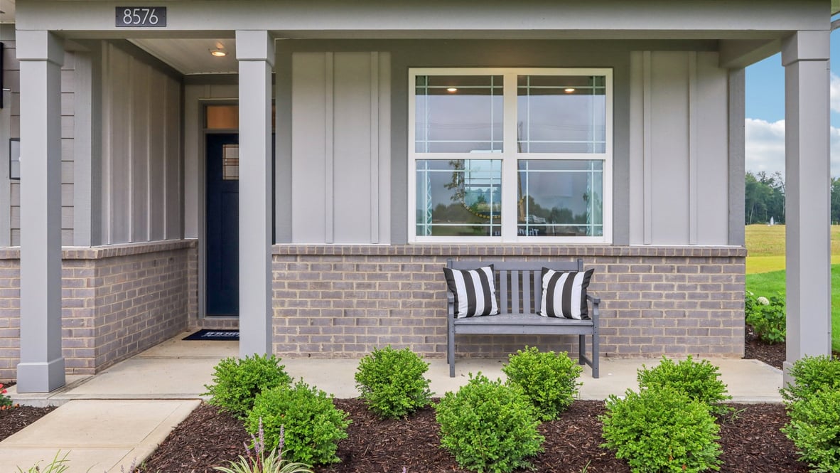 covered patio on the front of the home