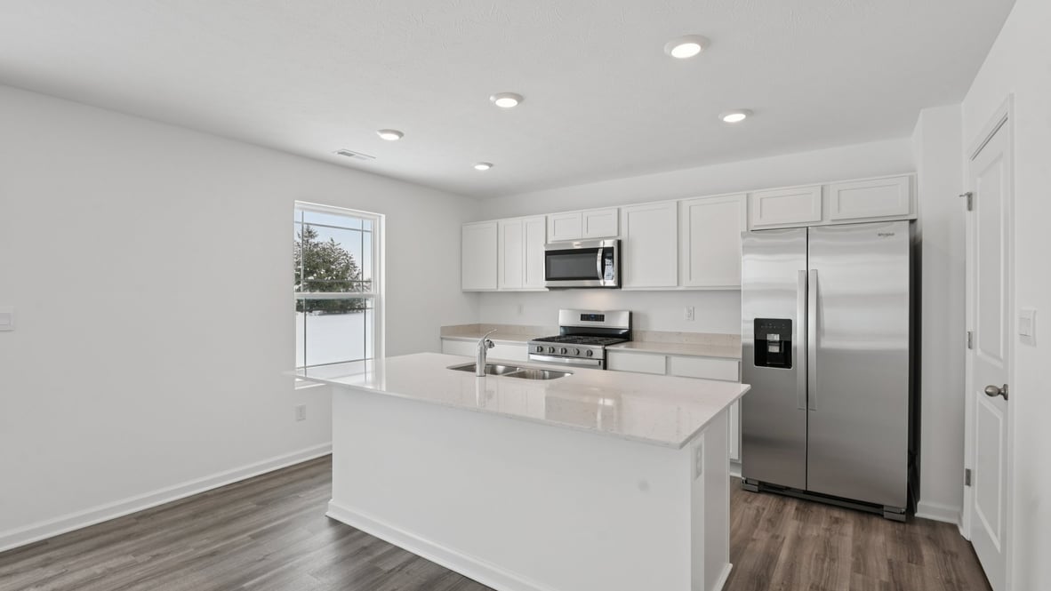 kitchen with white cabinets, and quartz countertops