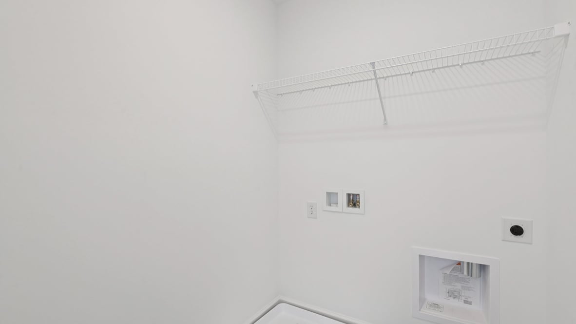 upper level laundry room with shelving