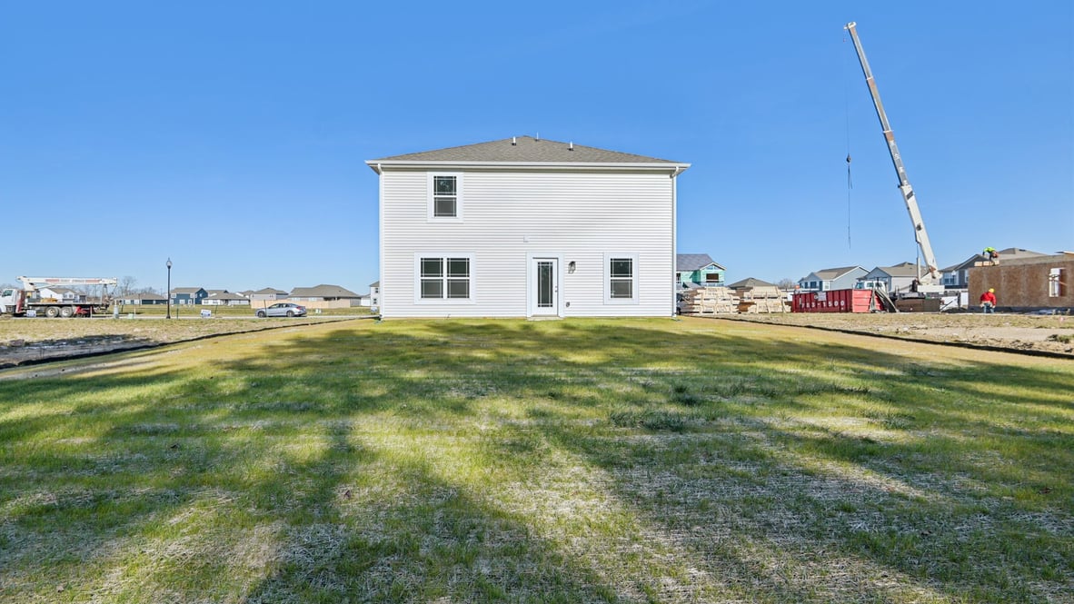 rear view of home with spacious front yard