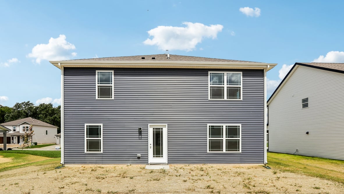 New house by D.R. Horton featuring a concrete patio for seating, grill setup, and a transition from indoor to outdoor living