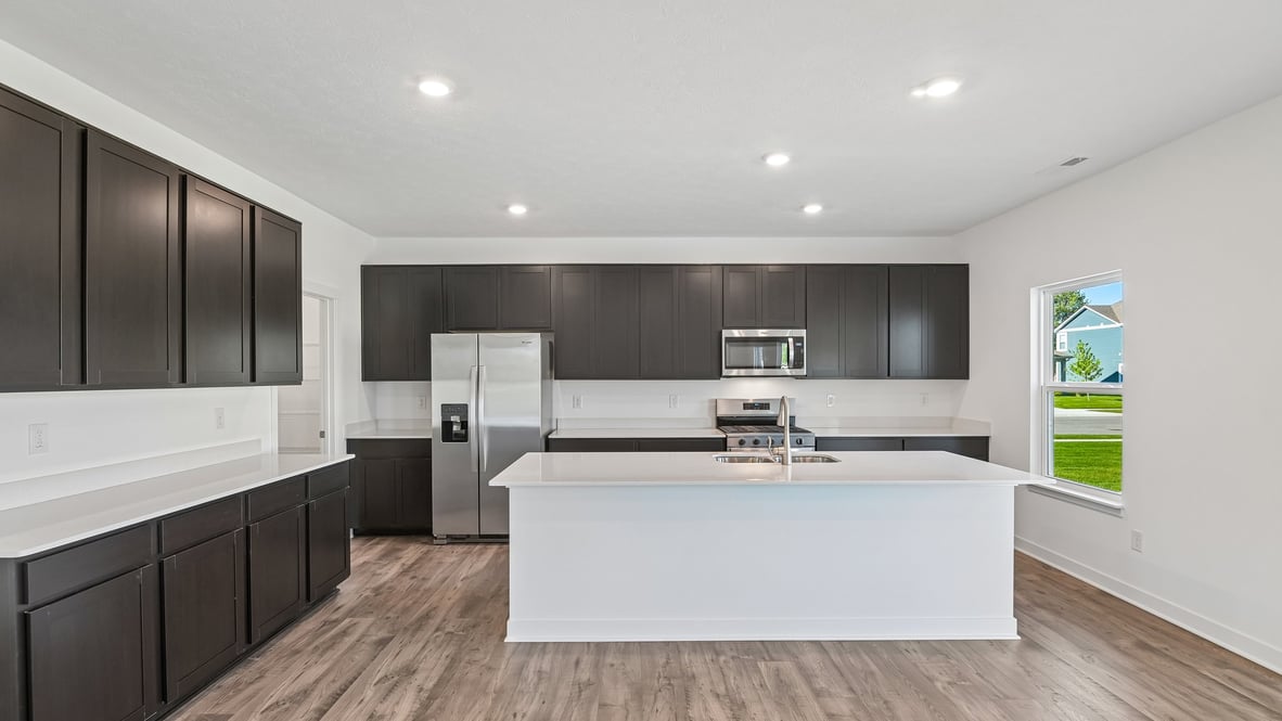 kitchen with quartz countertops and dark cabinets