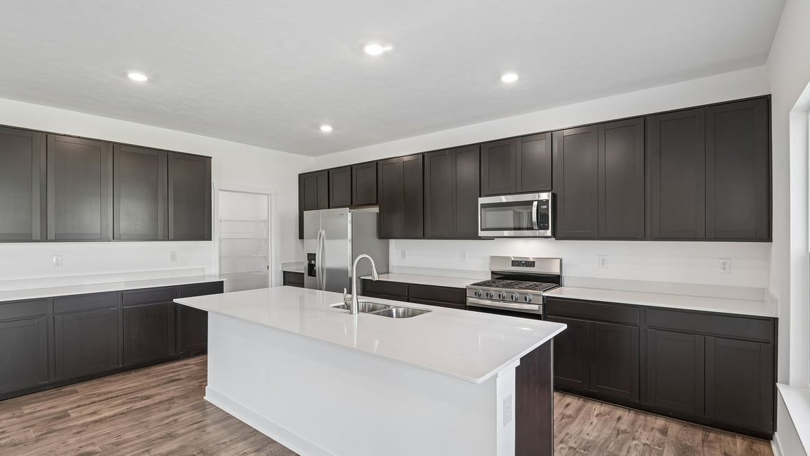 kitchen with quartz countertops and dark cabinets