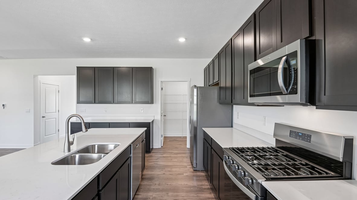 kitchen with quartz countertops and dark cabinets