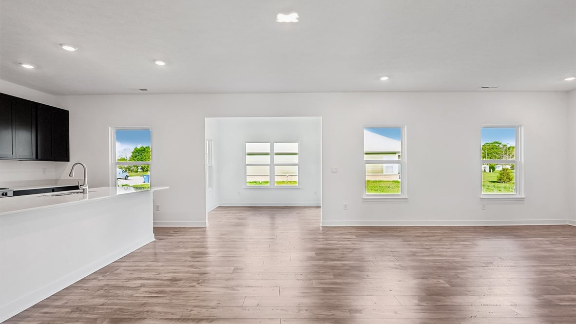 open concept living and dining area along with kitchen and sunroom