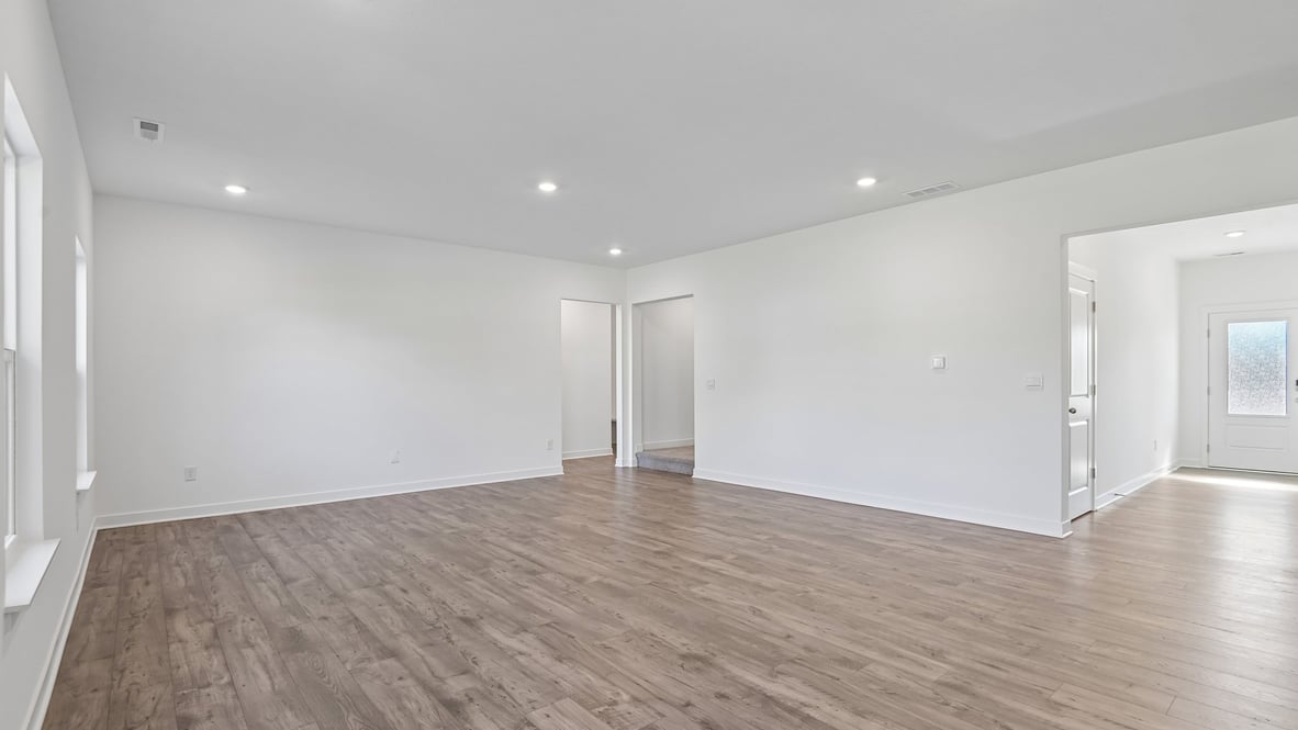 open concept living and dining area along with kitchen and sunroom