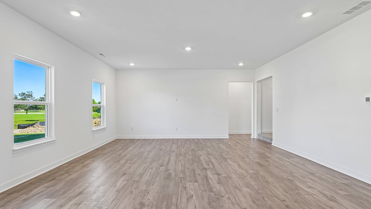 open concept living and dining area along with kitchen and sunroom