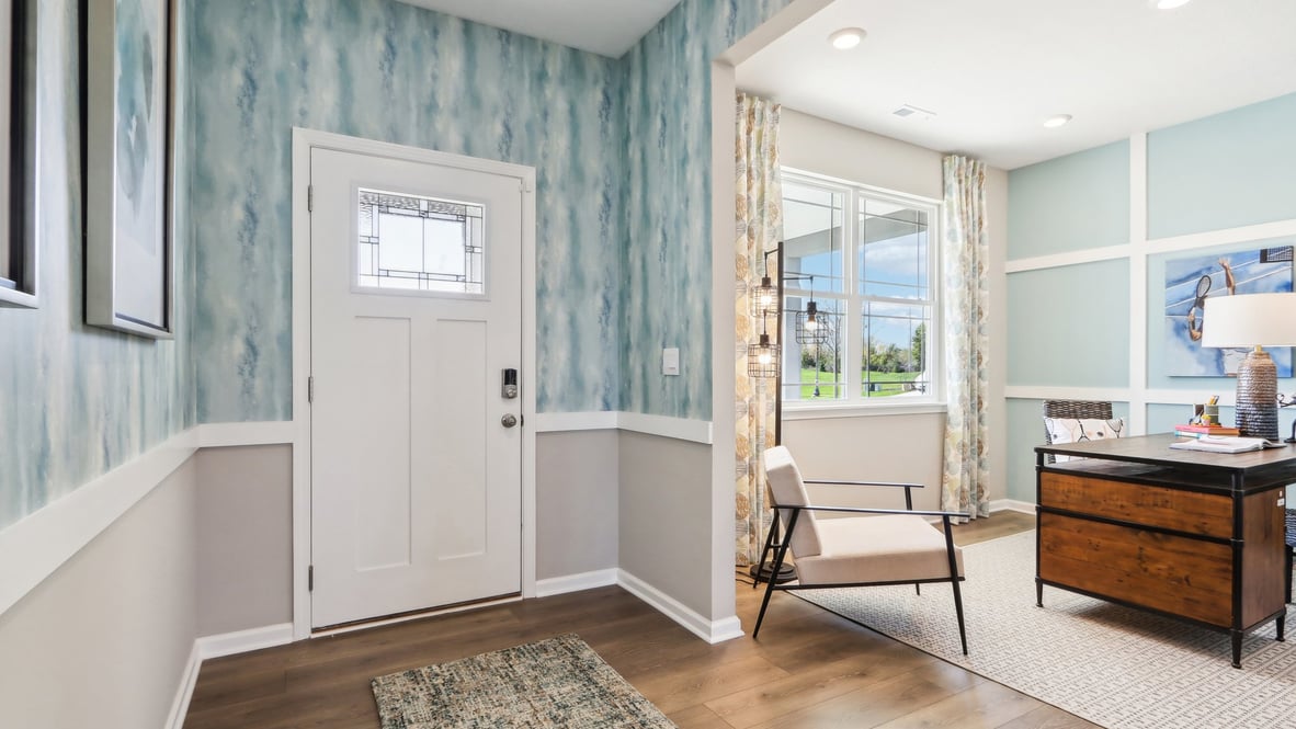 entry way with home office or den space to the left