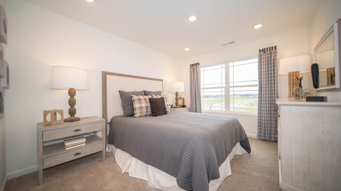 bedroom with queen bed dresser and nightstand
