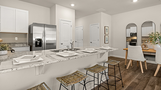 kitchen with quartz countertops and bar seating in townhome