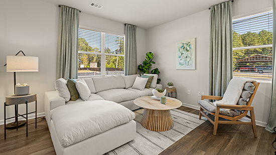 open concept townhome layout with bar seating and living and dining space