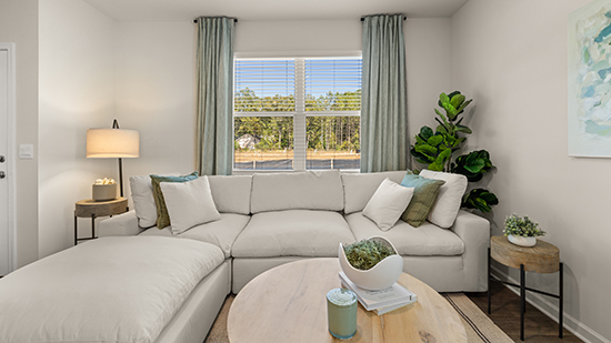 open concept townhome layout with bar seating and living and dining space