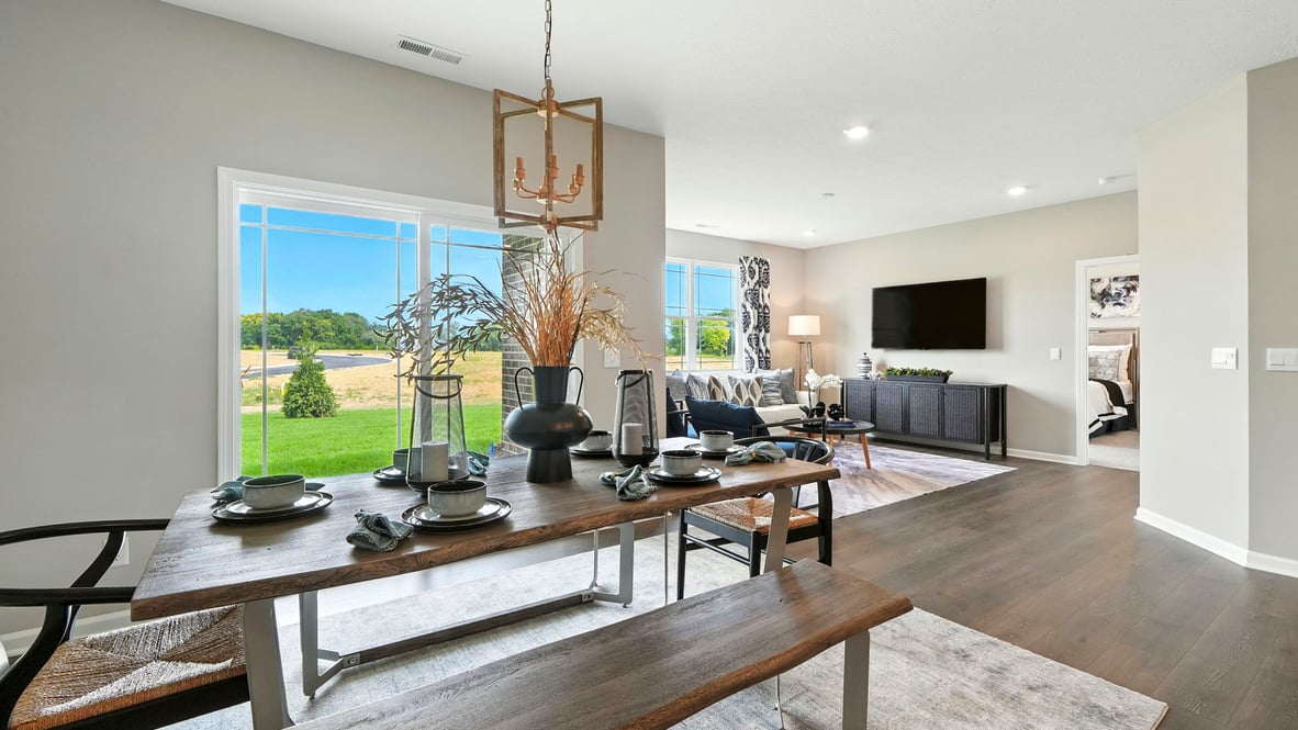 open concept dining and living room with natural lighting and covered porch