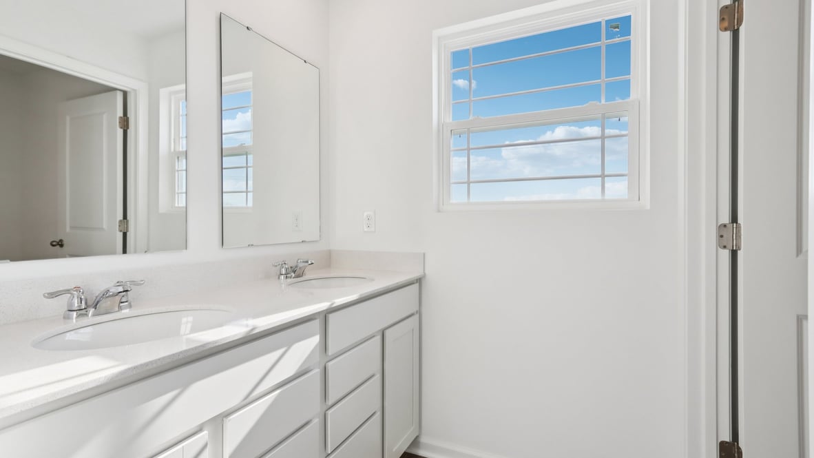 second full bathroom on the second floor with double vanity and private toilet and shower
