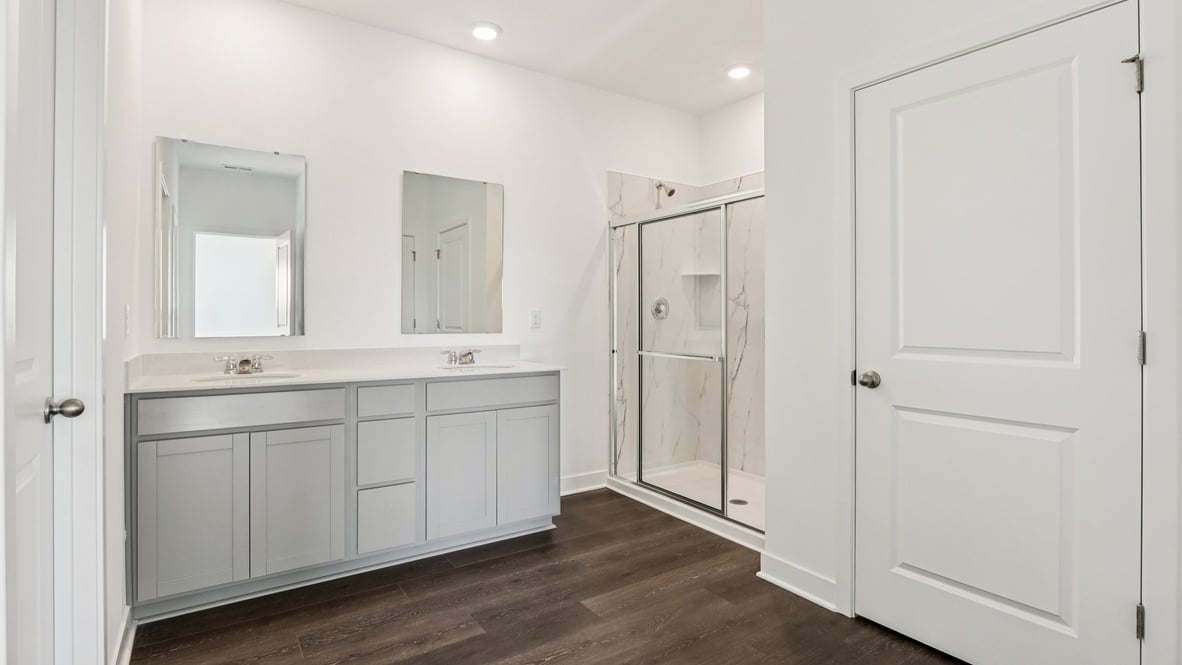 Primary bathroom with double vanity and walk in shower