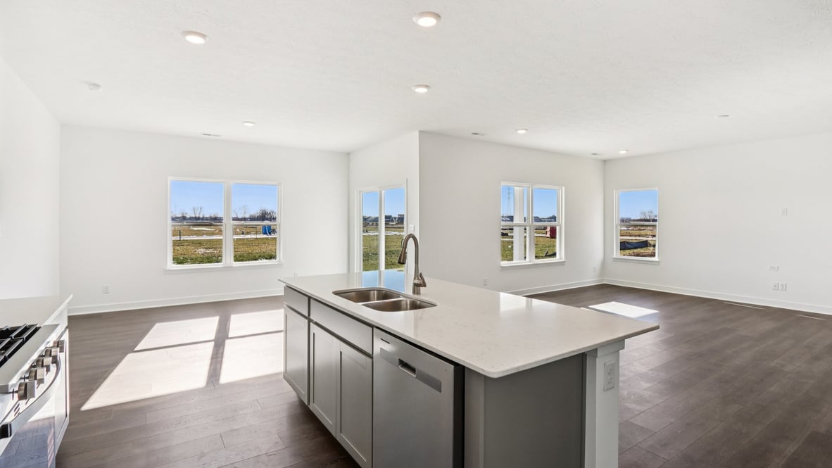 open concept kitchen with windows and large center island
