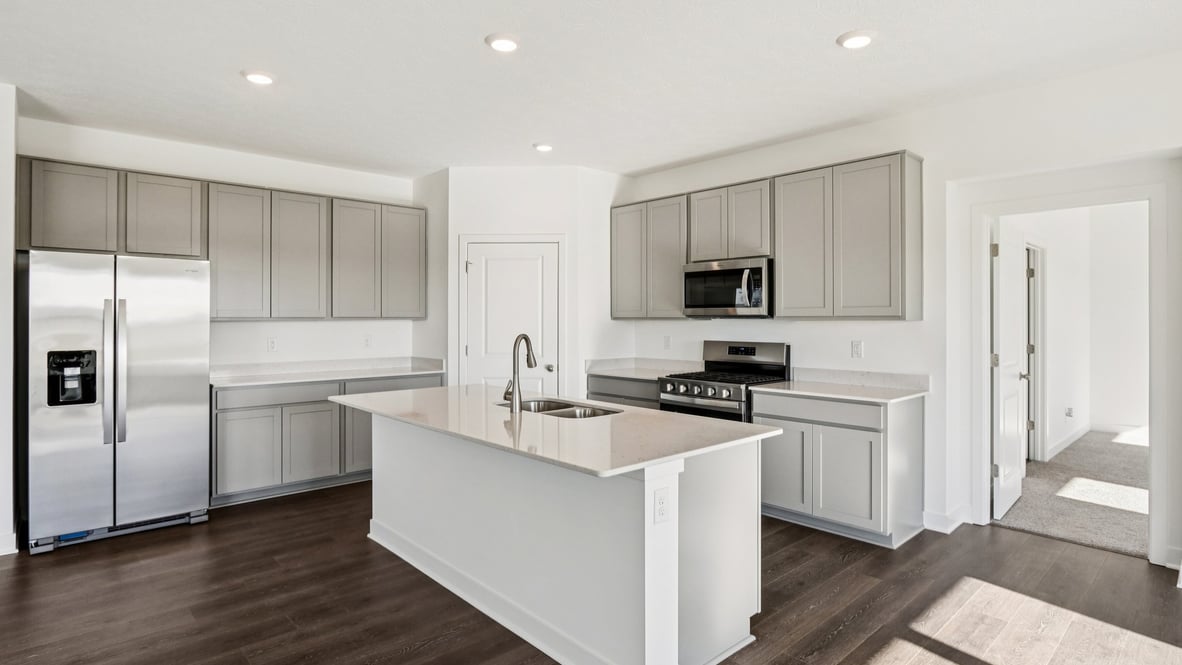 Large kitchen with walk-in pantry and center island quartz countertops