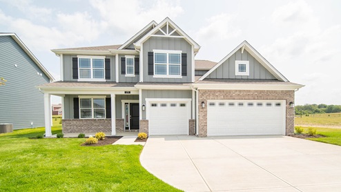 two story home with 3 car garage front exterior view