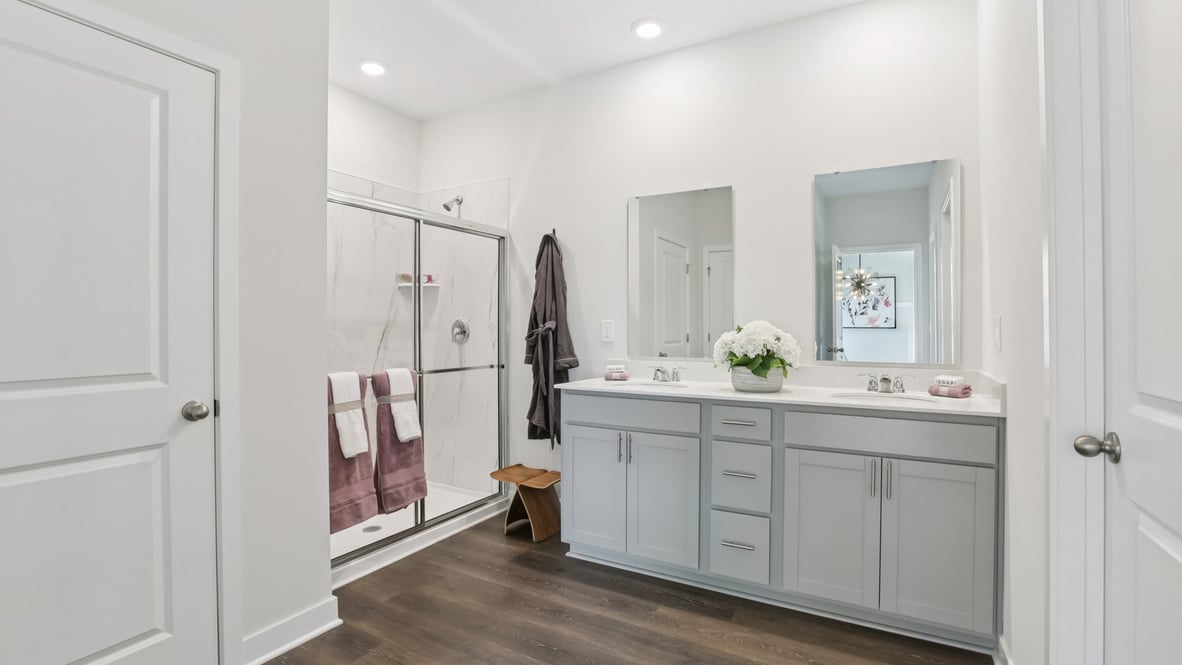 primary bathroom with dual vanity and walk-in shower