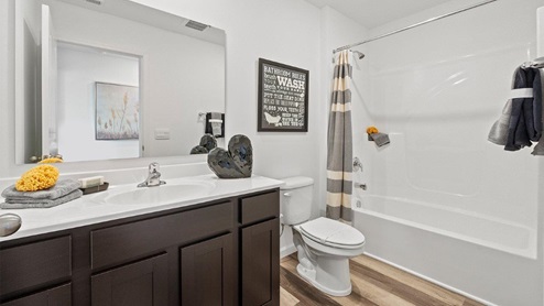 Colonial Heights Bellamy model home full bathroom with tub shower and LVP flooring