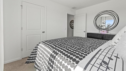 Colonial Heights Bellamy model home bedroom 4 with closet and carpeting