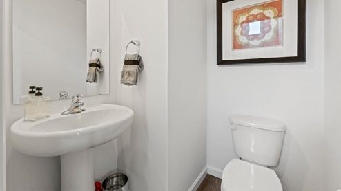 Colonial heights bellamy model home half bath with pedestal sink and LVP floors