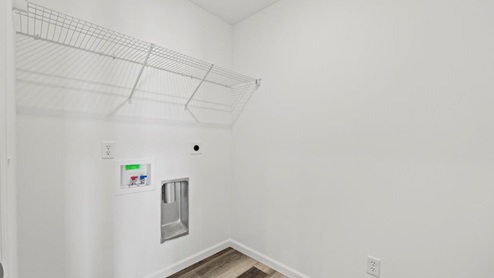 laundry room with hookups and shelving