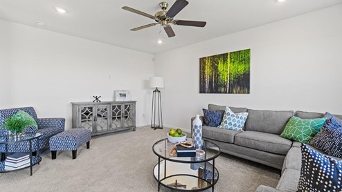 Livingston Lakes Holcombe model home living room with a large 52" ceiling fan