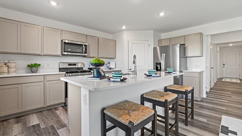 Livingston Lakes Holcombe model home kitchen with grey cabinetry with 30"upper cabinets