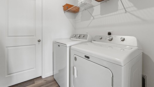 Livingston Laker Holcombe model home laundry room with LVP flooring and wire shelving