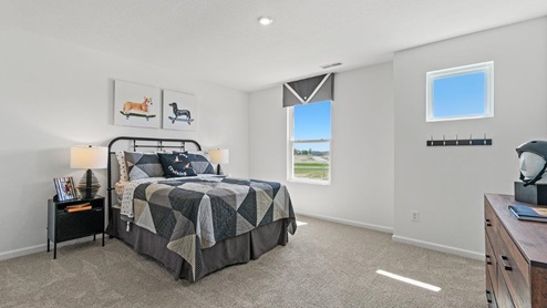 Livingston Lakes Holcombe model home bedroom 2 with carpet flooring
