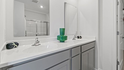 bathroom with dual vanity sink off of main bedroom