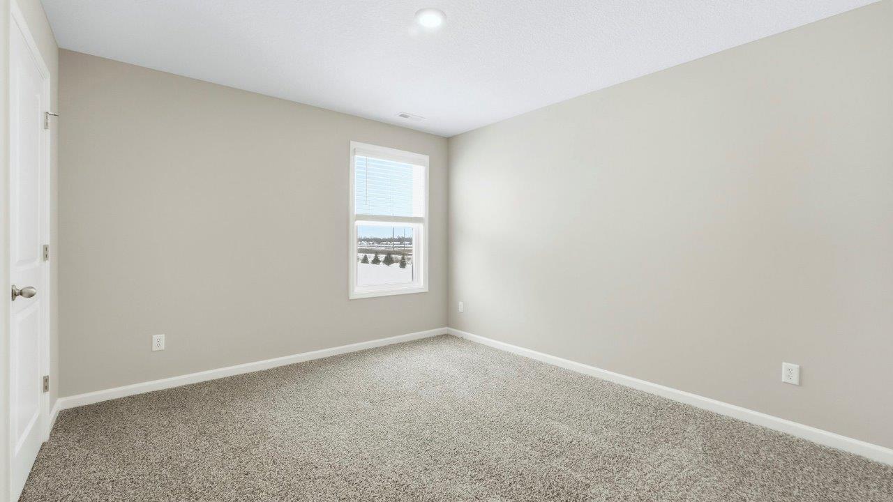 bedroom 2 with elk beige carpet, popular grey walls, 1 window, and closet