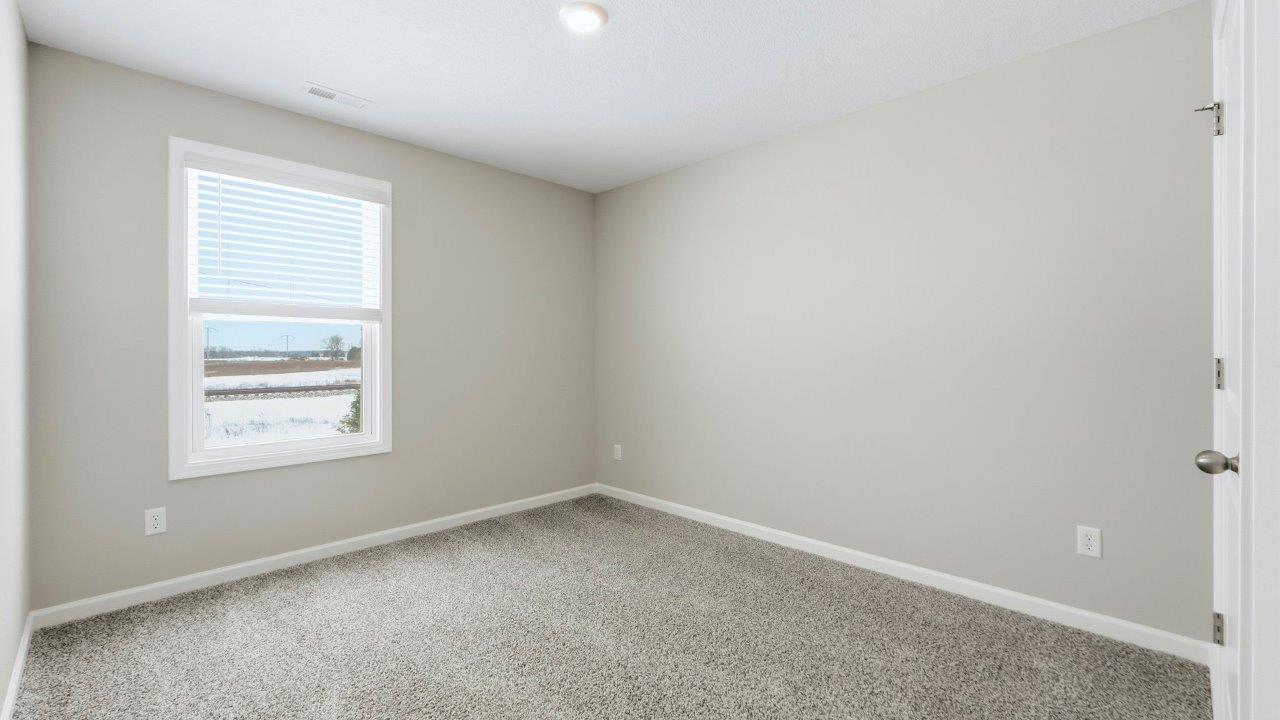 bedroom 3 with elk beige carpet, popular grey walls, 1 window, and closet