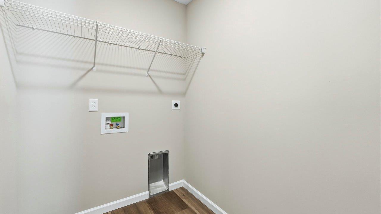 laundry room on second floor with lvp flooring, built-in shelf, and hookups for washer/dryer