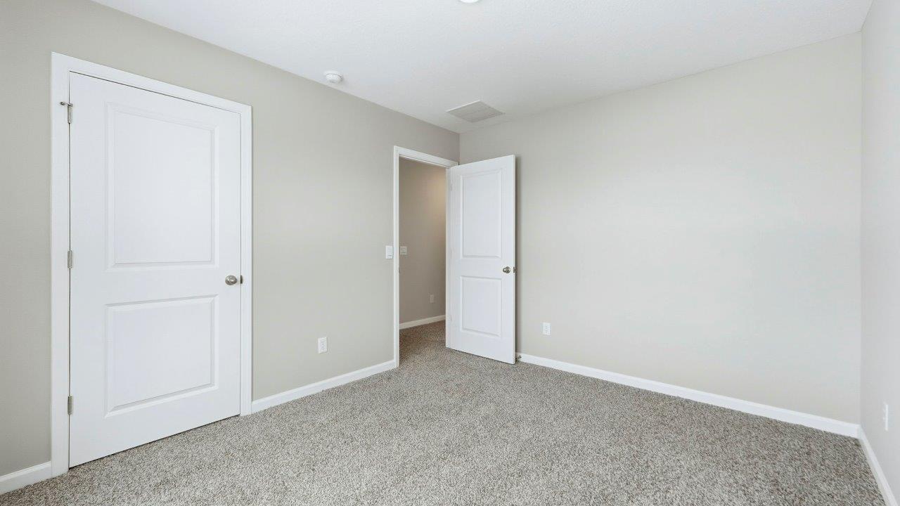 bedroom 4 with elk beige carpet, 2 windows, popular grey walls, and closet
