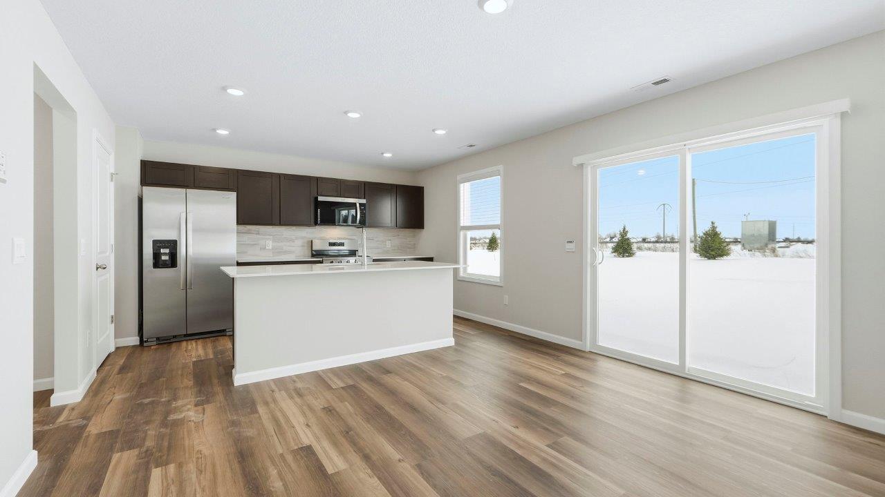 casual dining space with mohawk eastmont lvp and sliding door leading to backyard