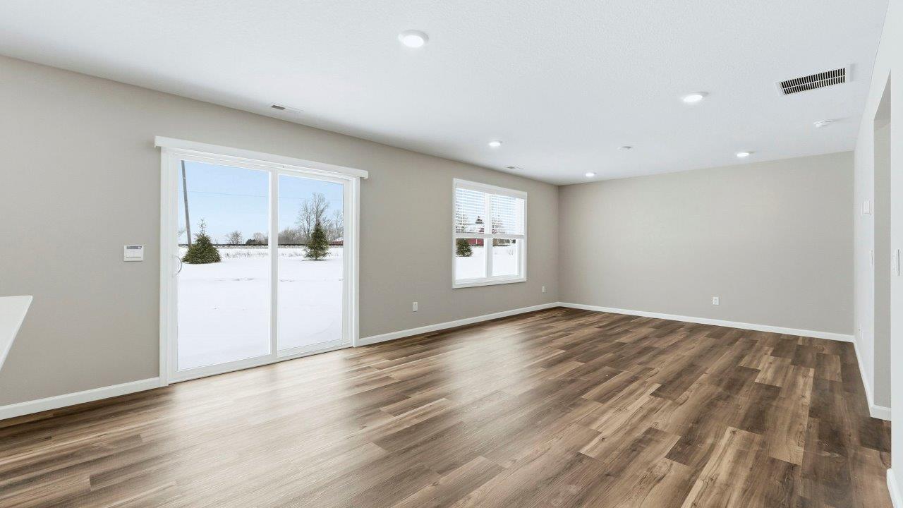 casual dining space with mohawk eastmont lvp and sliding door leading to backyard