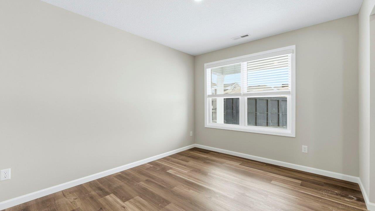 study with mohawk eastmont lvp, popular grey walls, 2 windows, and disc lighting.