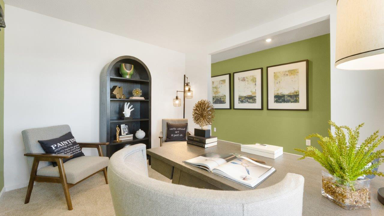 bellamy front of home study with carpet flooring, 2 windows, and green and white walls