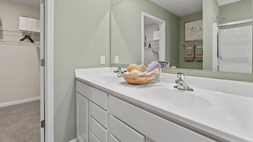 Trader's Trace Harmony Model Home dual sink bathroom off of main bedroom