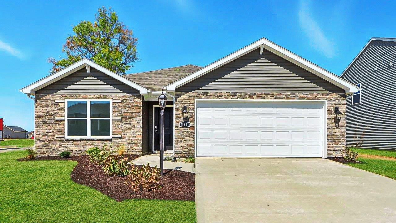 Traders trace spec home with 2 car garage, stone facade, and landscaping