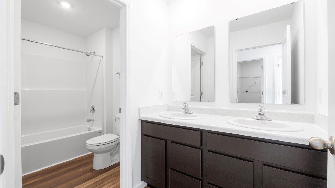 taylor full bath with dual sinks and tub shower